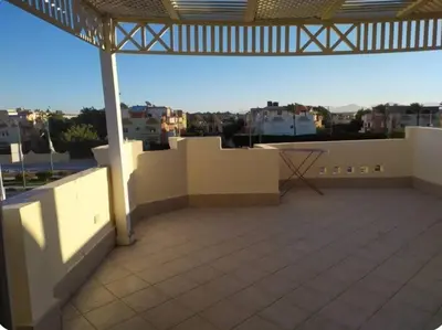 a balcony with a view of a city at One bedroom flat with large terrace in a villa with swimming pool in Hurghada