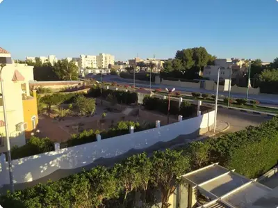a view of a parking lot from a building at One bedroom flat with large terrace in a villa with swimming pool in Hurghada