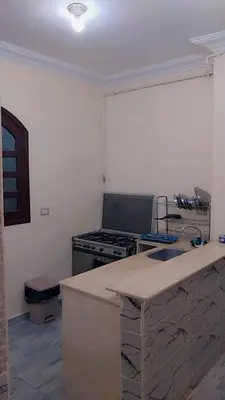 a kitchen with a stove and a counter top at Luxor downtown in Jazīrat al ‘Awwāmīyah
