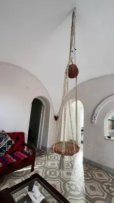 a living room with a swing hanging from the ceiling at Beit El-Abd Valley of Queens View in Luxor