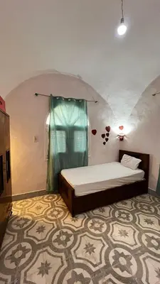 a bedroom with a bed and a window in a room at Beit El-Abd Valley of Queens View in Luxor
