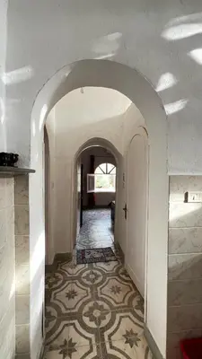 an archway in a house with a tile floor at Beit El-Abd Valley of Queens View in Luxor