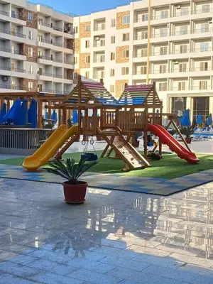 a playground in a park with a slide at Golden tiba resort in Hurghada