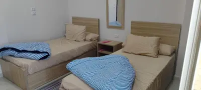 two beds in a small room at Sea View Qussier in Quseir