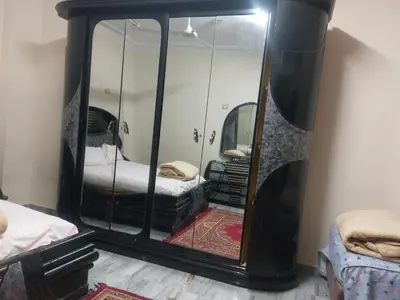 a large mirror in a room with a bed and a bed sqor at Horus apartment in Al Bayāḑīyah