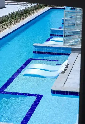 a blue swimming pool with blue tiles on the ground at SRNTY Sahl Hasheesh - Ex Serenity Sky Arc in Hurghada