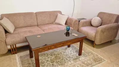 a living room with a couch and a coffee table at House Mountain in Luxor