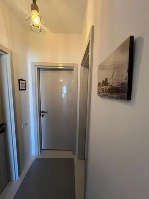 a hallway with a door and a picture on the wall at Hotel apartment swan lake in Hurghada