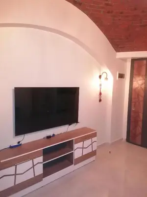 a living room with a flat screen tv on a wall at الكوثر القديم الغردقة in Hurghada