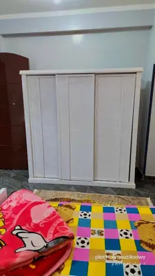 a white cabinet with a colorful rug on the floor at sky spirit in Luxor
