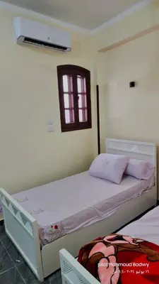 a bedroom with a white bed with a window and a bed sidx sidx at sky spirit in Luxor