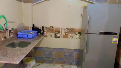 a kitchen with a sink and a refrigerator at habby home in Aswan