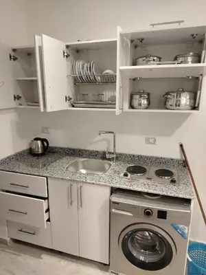 a kitchen with a sink and a washing machine at Hurghada Fiesta Resort Studio 328 in Hurghada