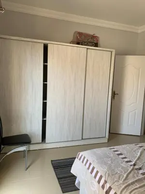 a bedroom with white cabinets and a bed in it at Apartment in centre of Hurghada in Hurghada
