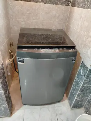 a toilet in a bathroom with a tiled wall at اسوان ـ خلف مول بلازا ـ بجوار فرست مول in Aswān