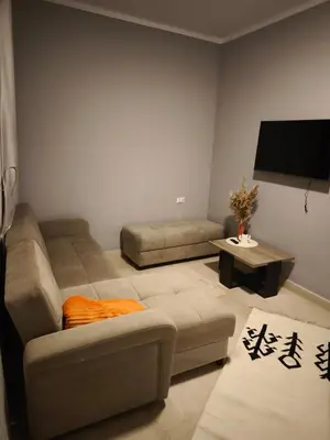 a living room with a couch and a flat screen tv at Soho compound in Hurghada