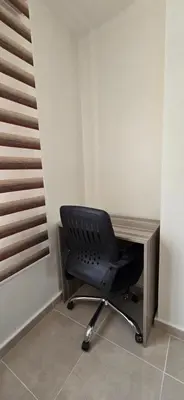 a black chair sitting in front of a desk at Tiba Golden Marina Bay Hurghada in Hurghada