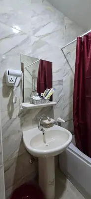 a bathroom with a sink and a tub with a mirror at Tiba Golden Marina Bay Hurghada in Hurghada