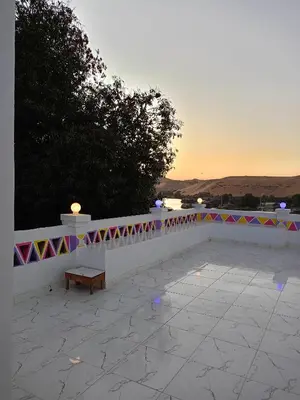 a bench sitting on top of a white wall at Toto Kato in Jazīrat Aswān