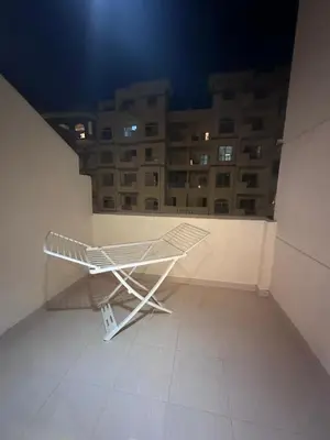 a white bench in a room with a building at Florenza Khamsin Resort in Hurghada