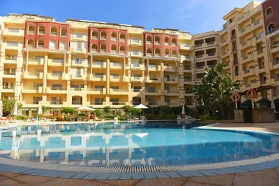 a large swimming pool in front of a building at Florenza Khamsin Resort in Hurghada