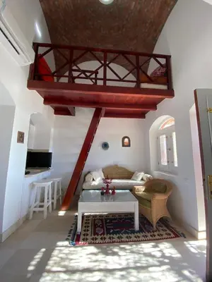 a living room with a couch and a table at Apartment at Upper Nubia lagoon El Gouna in Hurghada