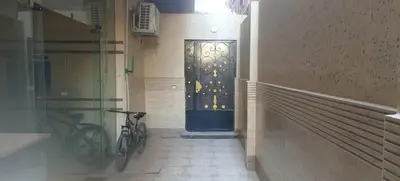 a black door in a hallway with a bike at Al Khaother in Hurghada