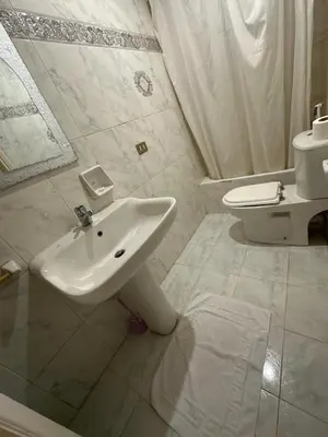 a white bathroom with a sink and a toilet at Paradise Villa Seaview in Hurghada