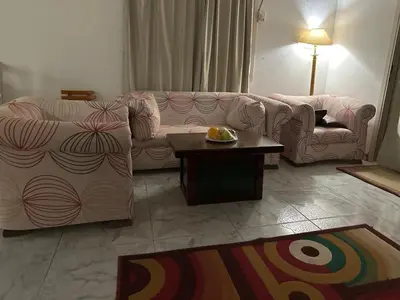 a living room with two couches and a table at Paradise Villa Seaview in Hurghada