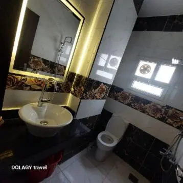 a bathroom with a sink and a toilet and a mirror at Modern studio in Hurghada