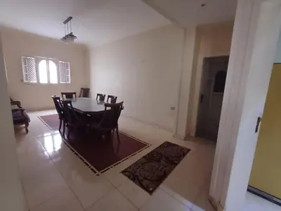 a dining room with a table and chairs at Ahmeds in Luxor
