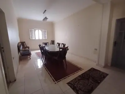 a dining room with a table and chairs at Ahmeds in Luxor
