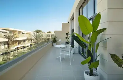 a balcony with a table and chairs on a building at Cozy getaway in El Gouna with pool & mountain view in Hurghada
