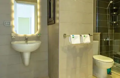 a bathroom with a sink and a toilet and a window at Cozy getaway in El Gouna with pool & mountain view in Hurghada