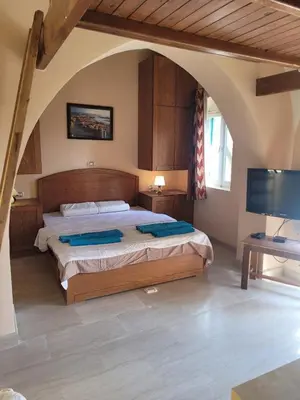 a bedroom with a large bed and a flat screen tv at Charming Studio in Downtown El Gouna in Hurghada