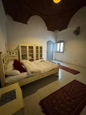 a bedroom with a large bed in a room at Sahara palace in Luxor