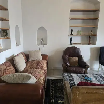 a living room with a couch and a chair at Sahara palace in Luxor