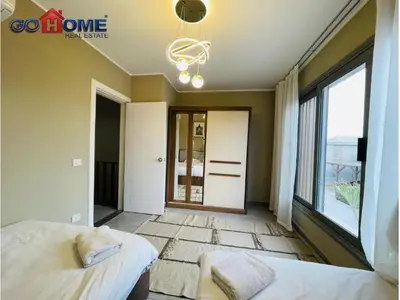a bedroom with two beds and a large window at 3 Bedroom In Bali Heated pool El Gouna in Hurghada