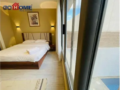a bedroom with a bed and a large window at 3 Bedroom In Bali Heated pool El Gouna in Hurghada