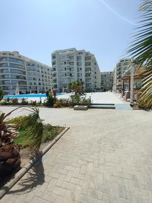 a brick walkway in a city with tall buildings at Scandic Resort in Hurghada