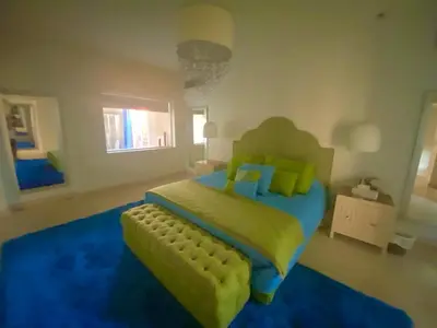 a bedroom with a large bed with a yellow bedspread at Abu Tig Marnia El Gouna MB04 in Hurghada