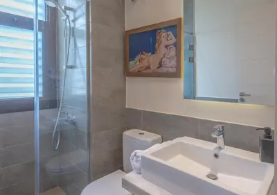 a bathroom with a toilet and a sink and a shower at 4BR Cyan Dream Villa I Pool Lagoon & Sauna in Hurghada