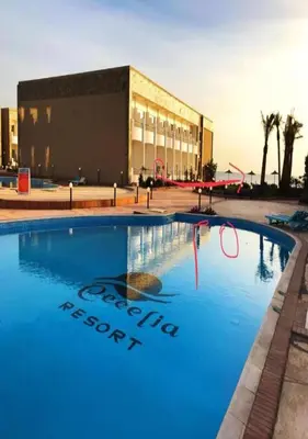 a large swimming pool in front of a building at Steps from Beach & Near Airport Furnteched, Kitchenette, full APT Free WIFI in Hurghada
