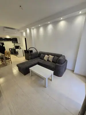 a living room with a couch and a coffee table at Florenza Khamsin in Hurghada