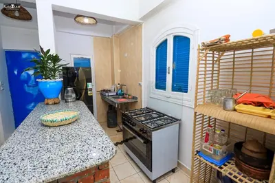 a kitchen with a stove and a counter top at Isis Club House in ‘Ezbet Abu Ḥabashi