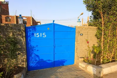 a blue garage door with the words isis on it at Isis Club House in ‘Ezbet Abu Ḥabashi