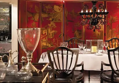 a dining room with a table with a white table cloth and a chandelier at Luxor Or Aswan Nile Cruise, Ultra Deluxe Cruises sailing 3, 4, Or 7 Nights in Luxor