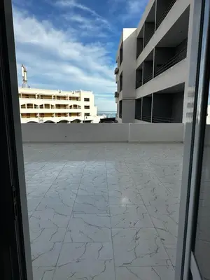 a view of a building from an open door at Wonderful sea view studio in Hurghada