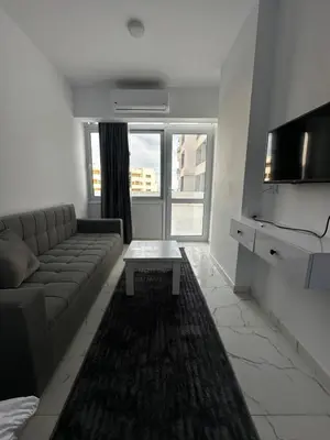 a living room with a couch and a tv at Wonderful sea view studio in Hurghada