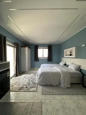 a bedroom with two beds and blue walls at Nile Spirit Sunset in Luxor